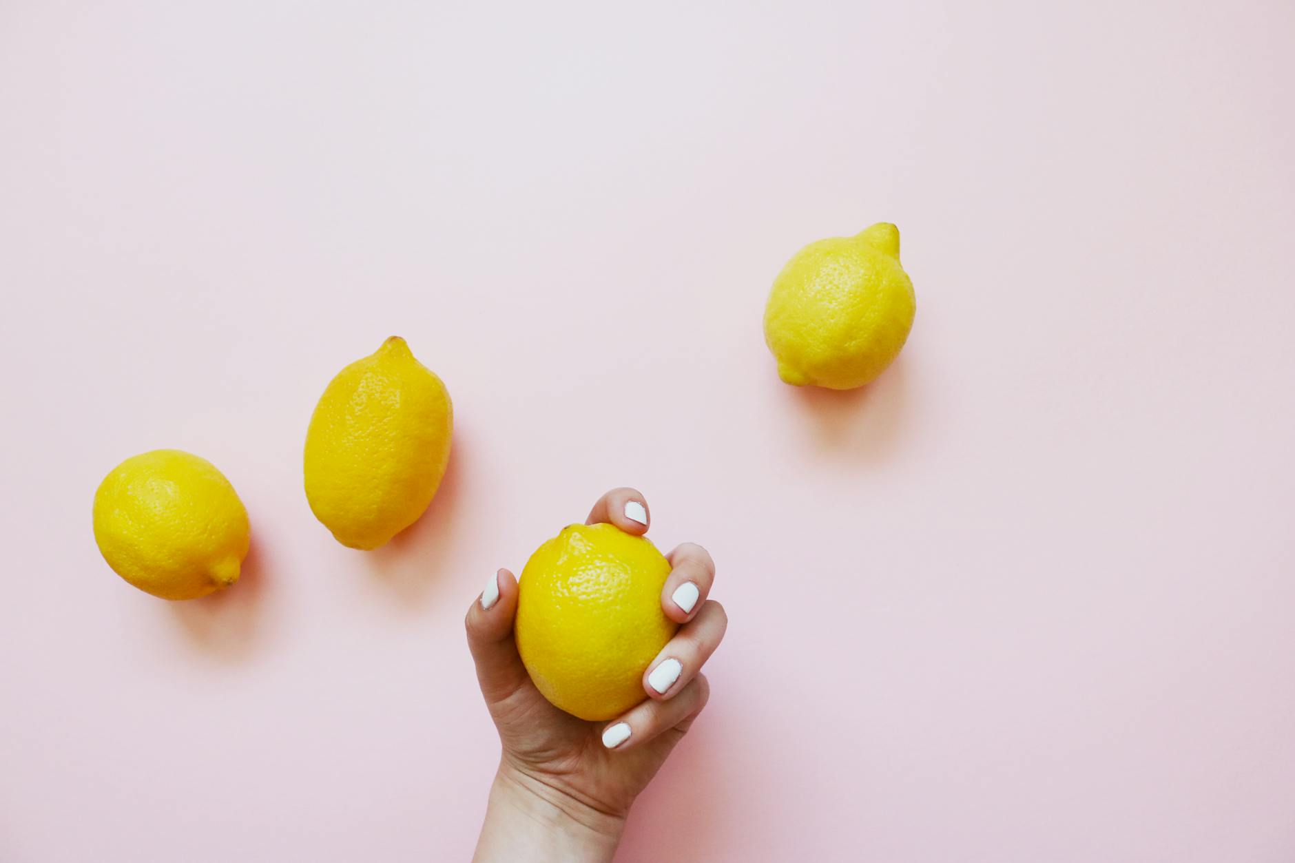 Two hands holding fresh lemons, symbolizing touch and sensation