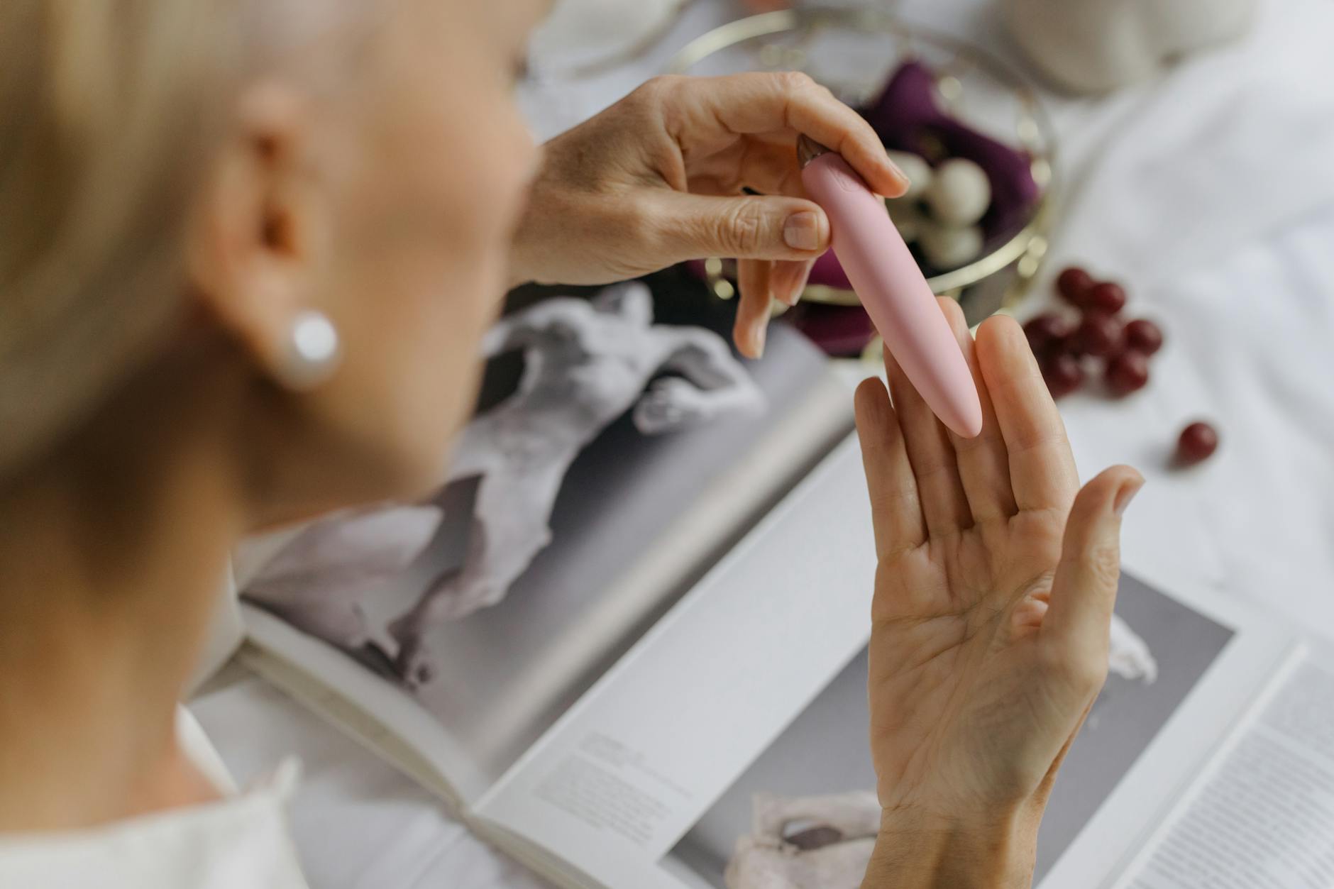 Close-up of hands exploring a vibrator together, representing intimate reconnection between partners