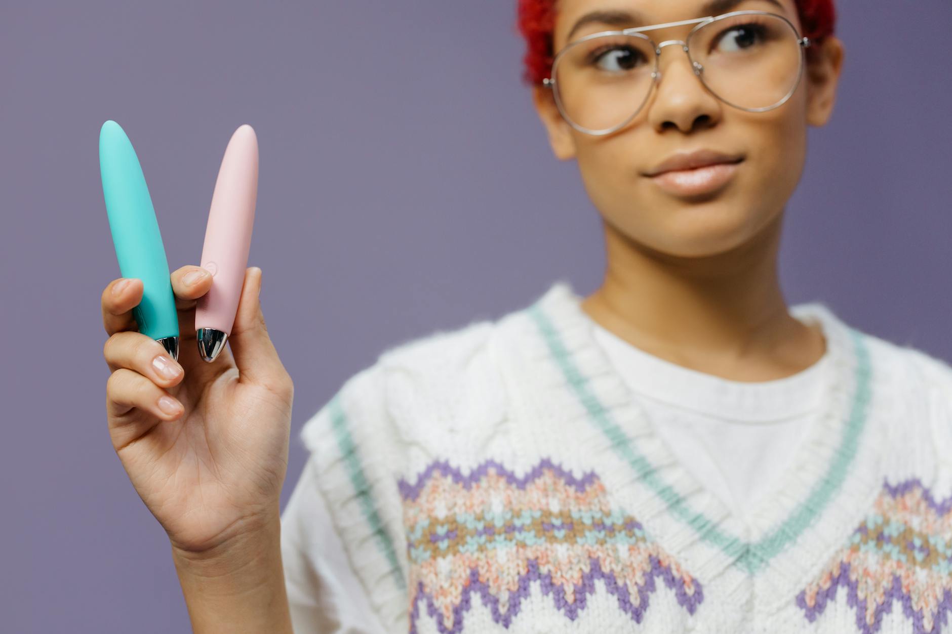 Hands holding a vibrator together, showing intimate connection and partnership
